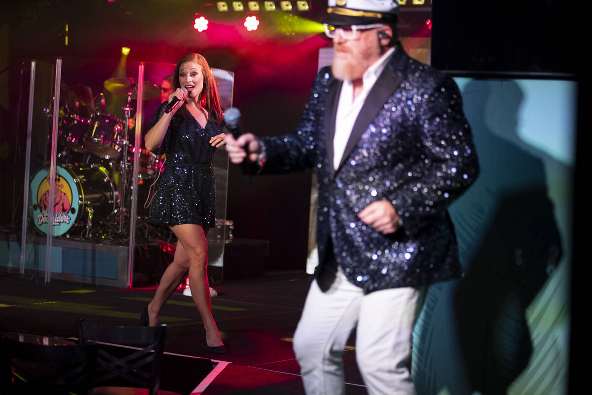 Erin Sucher, left, with her husband Kevin Sucher, of The Docksiders, perform during a show at t ...