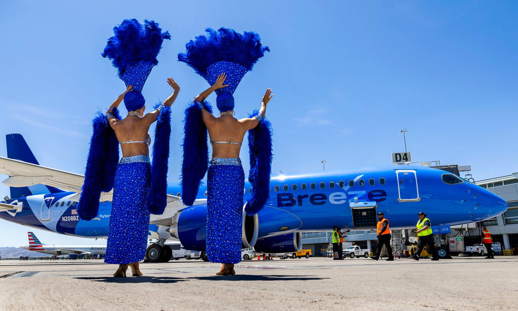 Showgirls Brooke, left, and Tara welcome passengers for the Breeze Airways inaugural flight arr ...