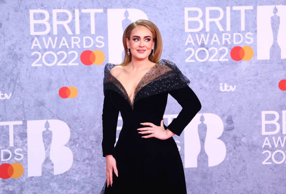 FILE - Adele poses for photographers upon arrival at the Brit Awards 2022 in London Tuesday, Fe ...