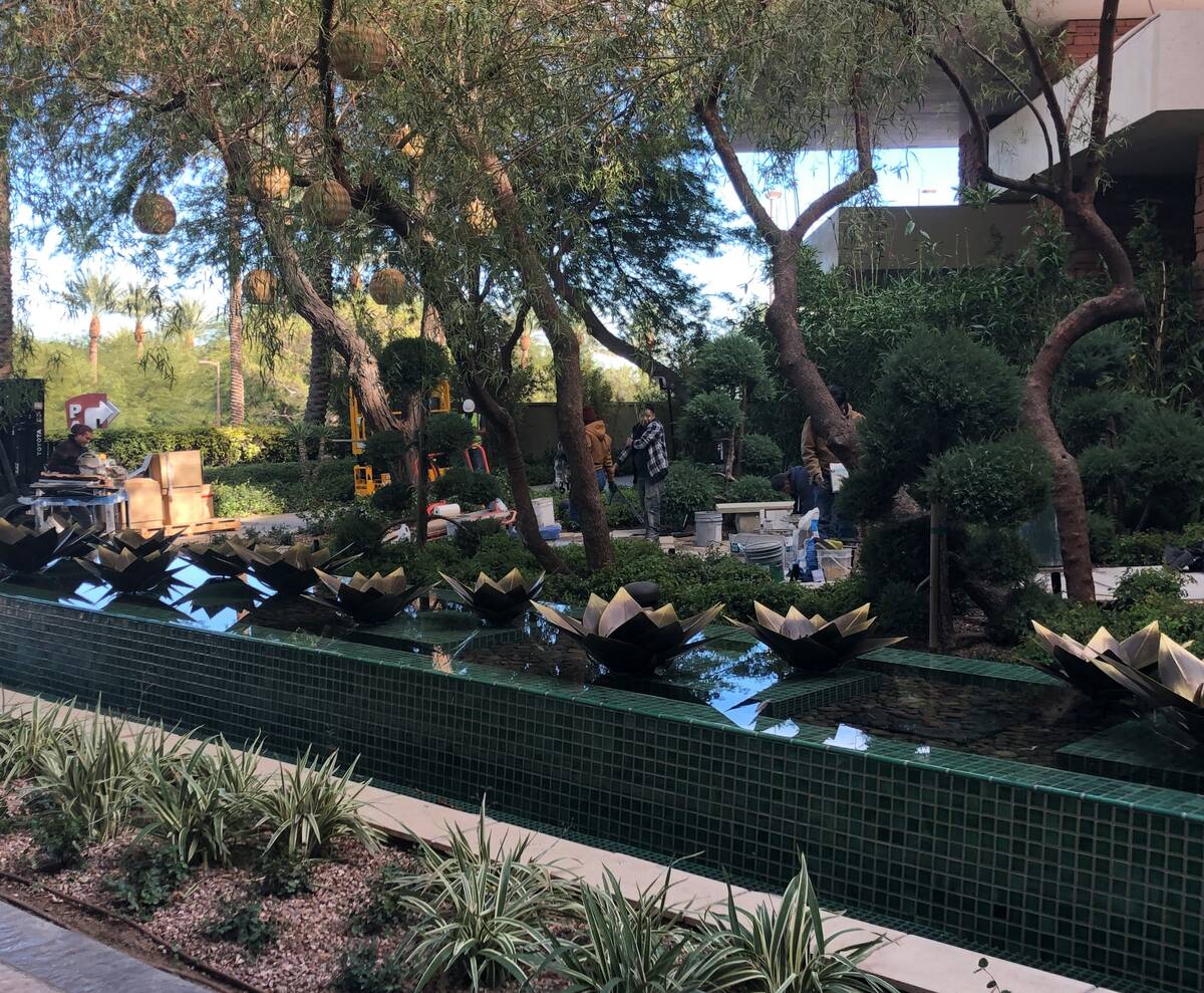 The reflecting pond with ornamental brass lotus blossoms outside the street entrance to the new ...