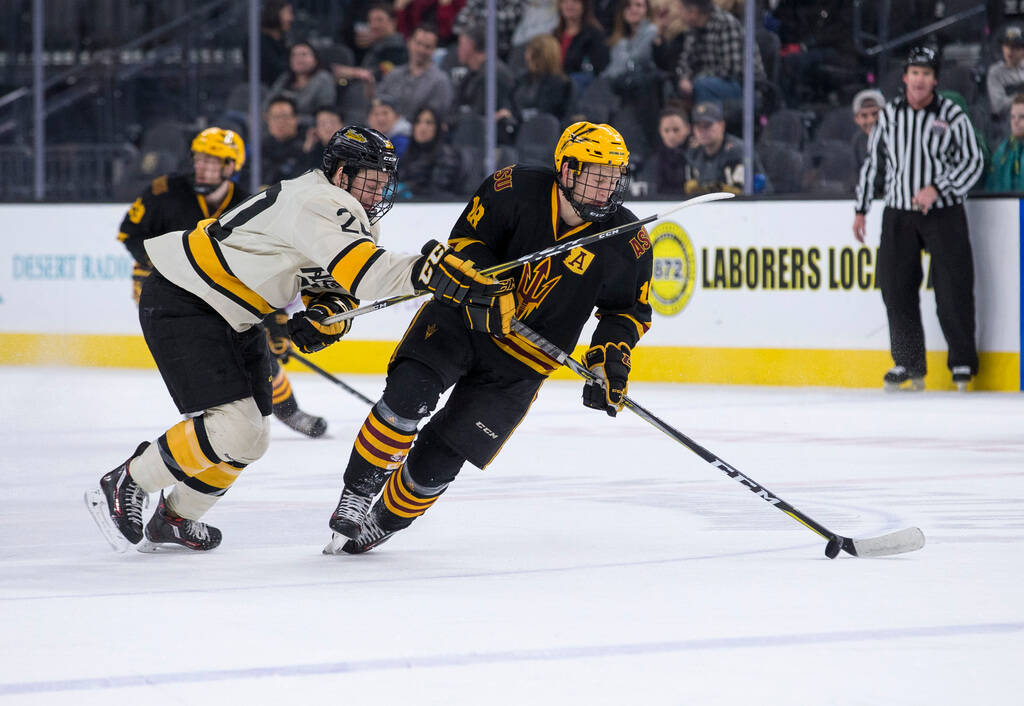 Arizona State Sun Devils forward Anthony Croston (18) controls the puck as Michigan Tech Huskie ...