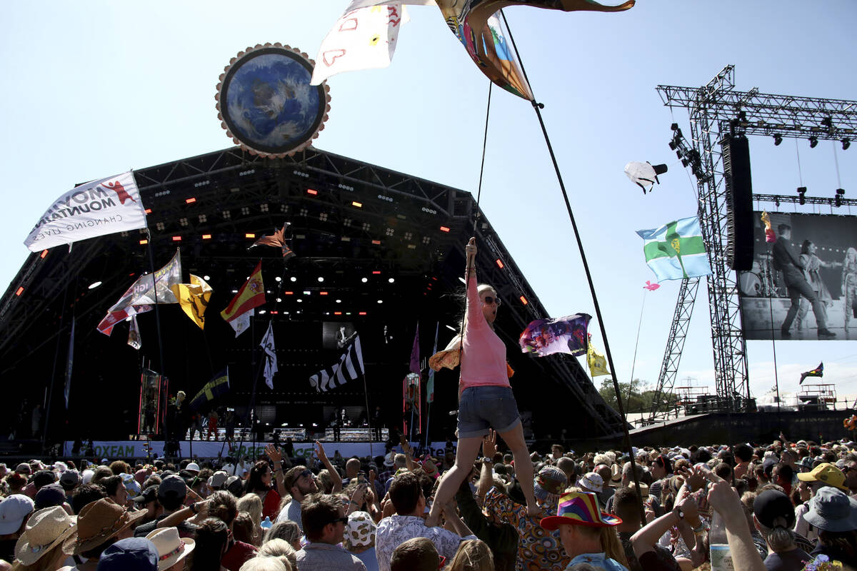 FILE - In this Sunday, June 30, 2019 file photo, revelers react to Kylie Minogue as she perform ...
