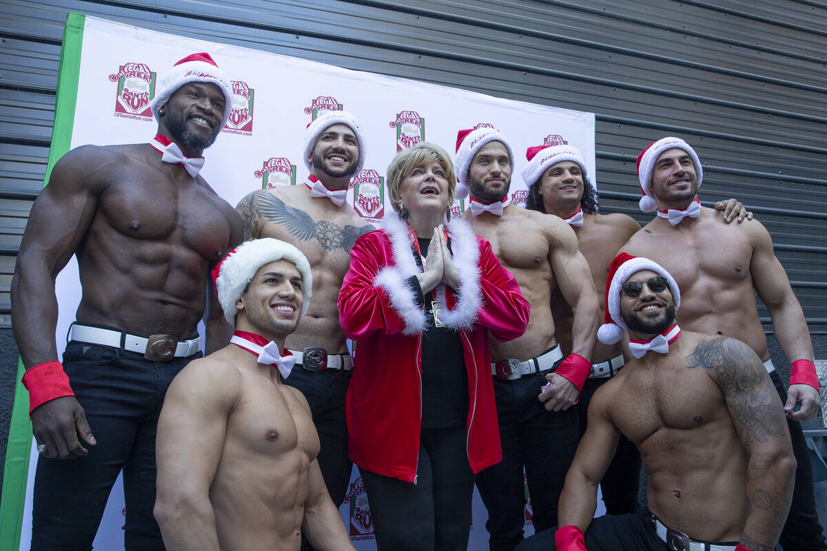 Mayor Carolyn Goodman poses for photos with Chippendales dancers at Fremont Street Experience d ...
