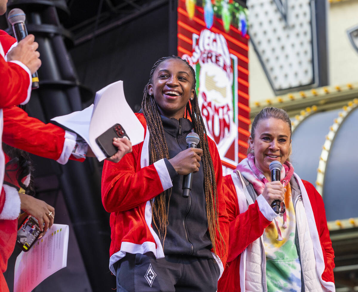 (LtoR) Aces player Jackie Young and Head Coach Becky Hammon joke around on stage during the pre ...
