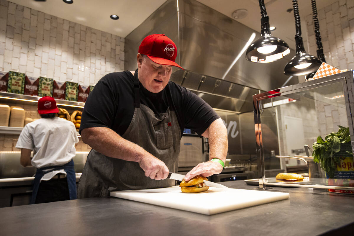 Chef James Trees, shown here preparing a signature chicken parm sandwich, is opening Bar Bohèm ...
