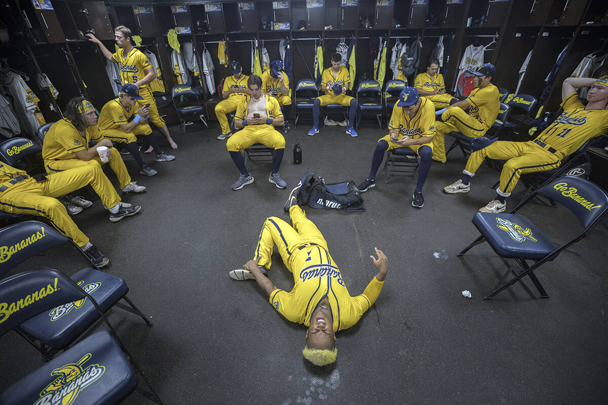 Savannah Bananas center fielder Ty Jackson, bottom center, with banana yellow hair, stretches i ...