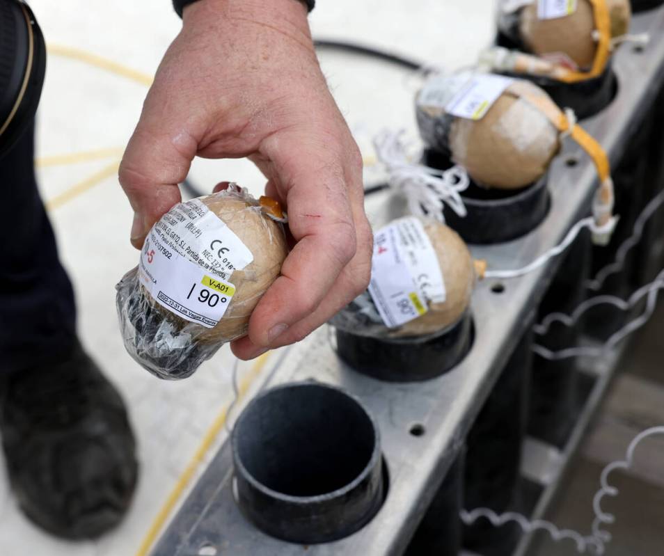 Fireworks by Grucci pyro technician Michael Wassmer shows a pyrotechnics shell while working on ...