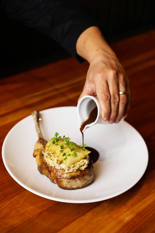 Kurobuta pork tomahawk at Michael Mina’s StripSteak at Mandalay Bay in Las Vegas, Wednes ...