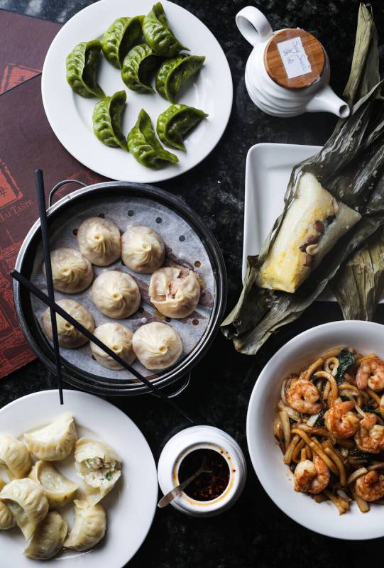 A swath of Chinese New Year dishes, from bottom left going clockwise: steamed fish dumplings, x ...