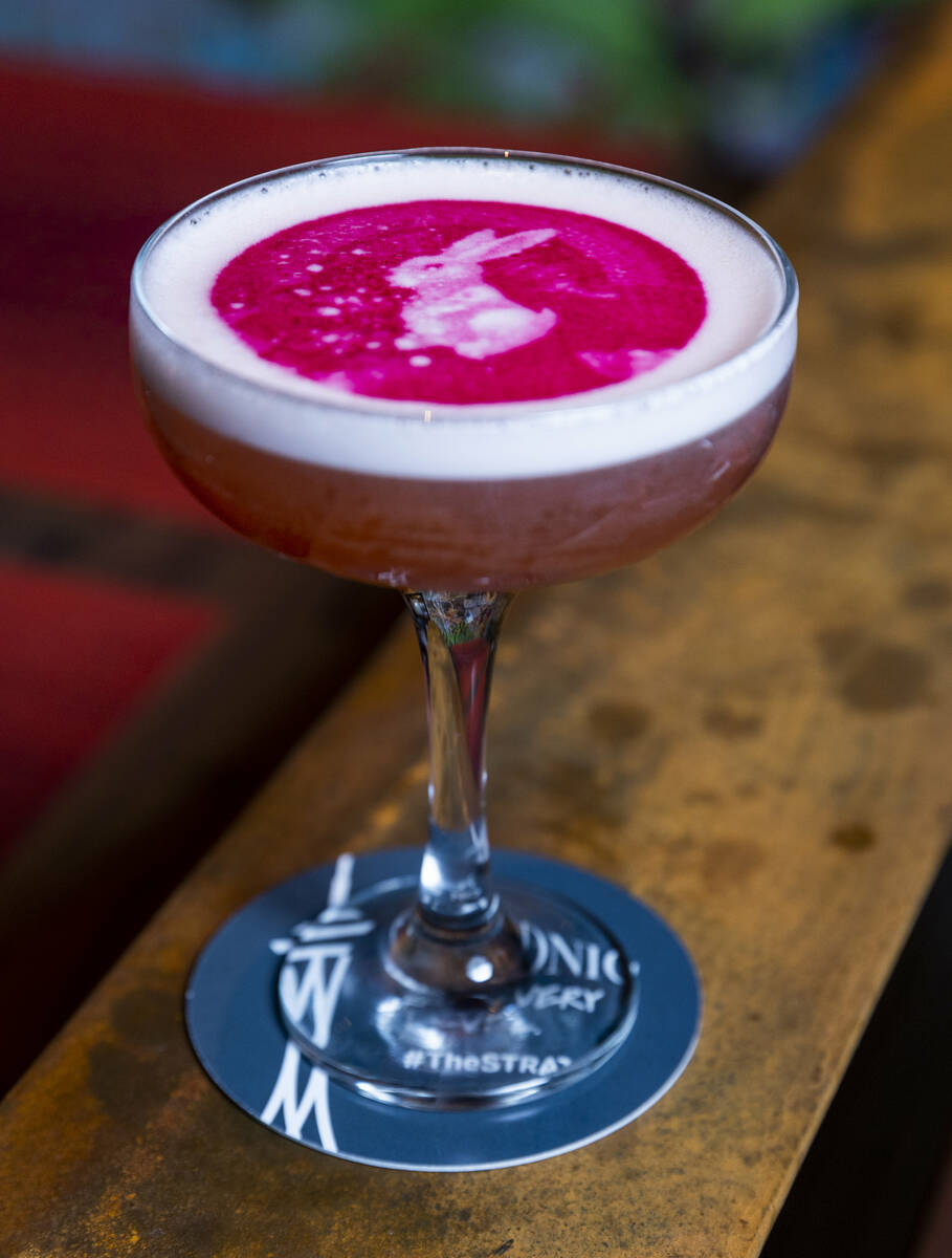 A Lunar Moon Shadow cocktail with printed rabbit atop the bar of Chi Asian Kitchen at The Strat ...