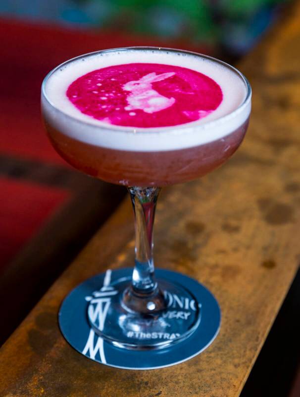 A Lunar Moon Shadow cocktail with printed rabbit atop the bar of Chi Asian Kitchen at The Strat ...