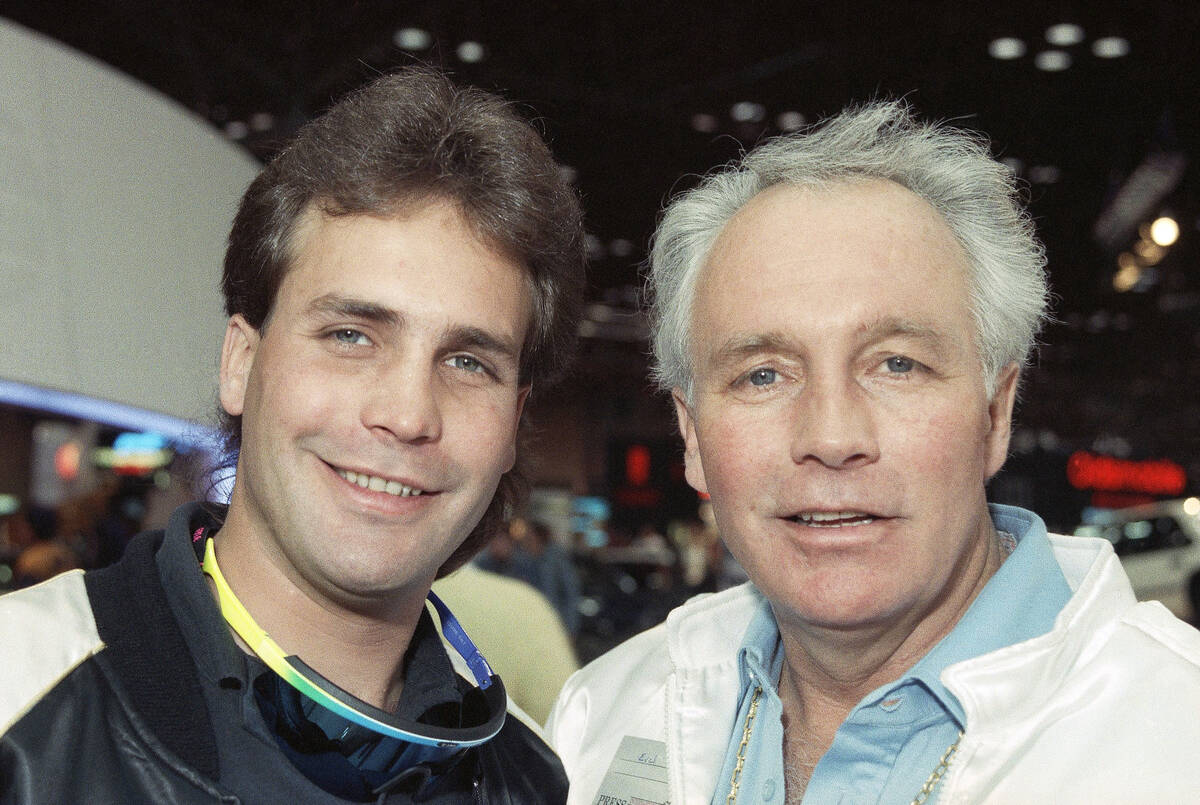 Motorcycle daredevil Robbie Knievel, left, poses with his famous father, Evel Kneivel, at a New ...
