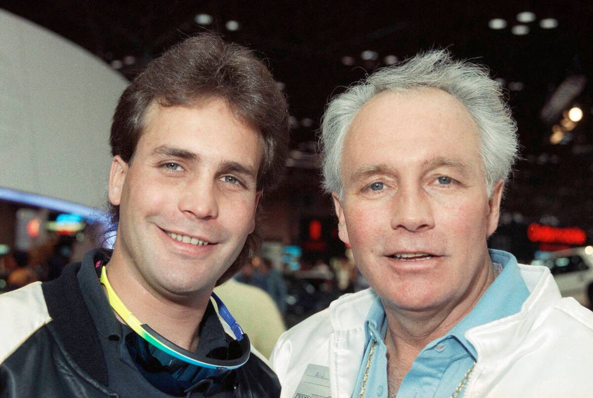 Motorcycle daredevil Robbie Knievel, left, poses with his famous father, Evel Kneivel, at a New ...