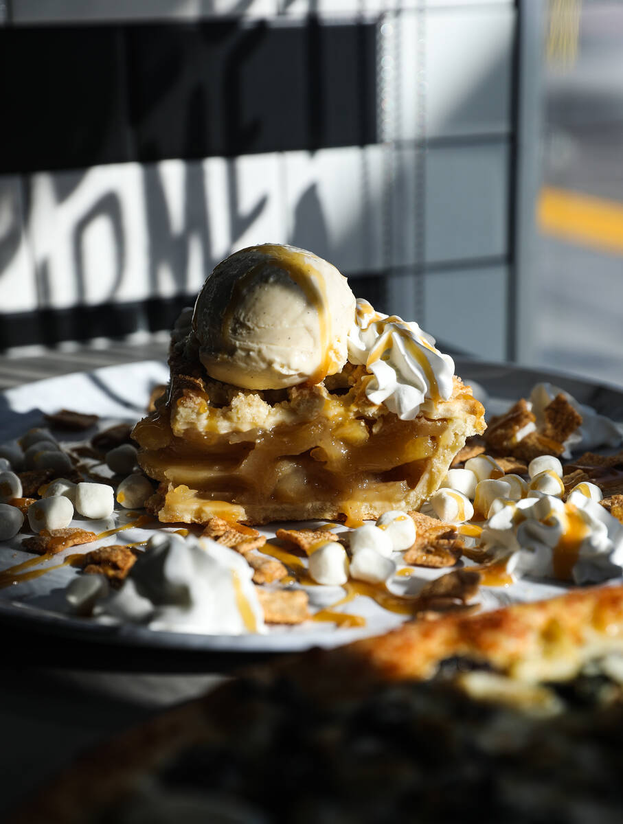 The cinna a la mode dessert—a slice of apple pie with vanilla ice cream, whipped cream, ...