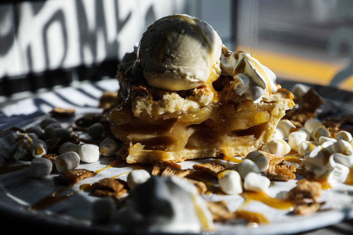 The cinna à la mode dessert — a slice of apple pie with vanilla ice cream, whipped cream, Ci ...