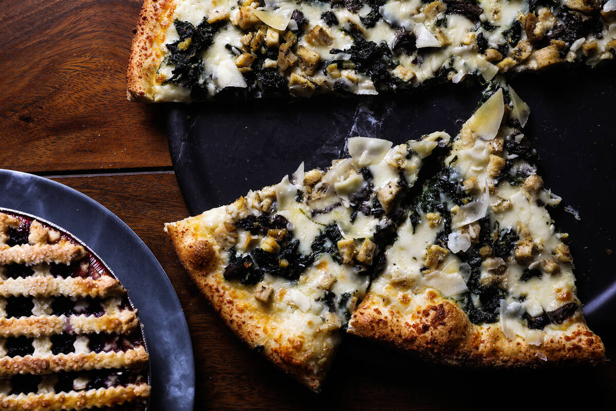 Blueberry pie, left, and the Roux pizza pie, right, at Crust & Roux in Las Vegas, Wednesday, Fe ...