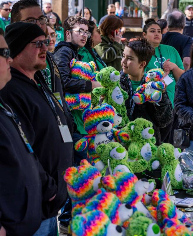 Mason Brooks, 12, shows off some stuffed bears which can be purchased as a donation during the ...