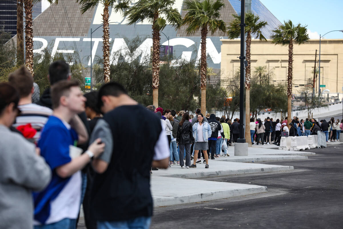 Fans wait in line for Taylor Swift merchandise at a pop-up store outside Allegiant Stadium in L ...