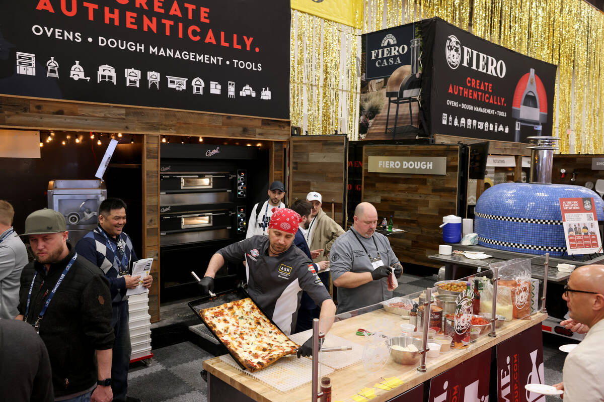 Pizza Artista Massimiliano Saieva of ASR PizzaLab academy prepares a pizza for sampling at the ...