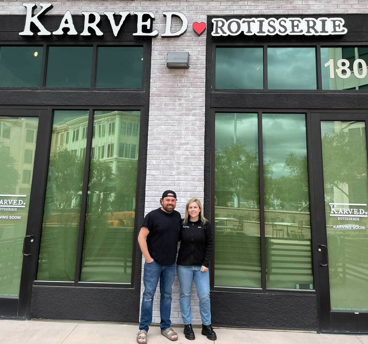 Owners Andy and Meghan Sparks take a moment in front of the new location of Karved, the rotisse ...
