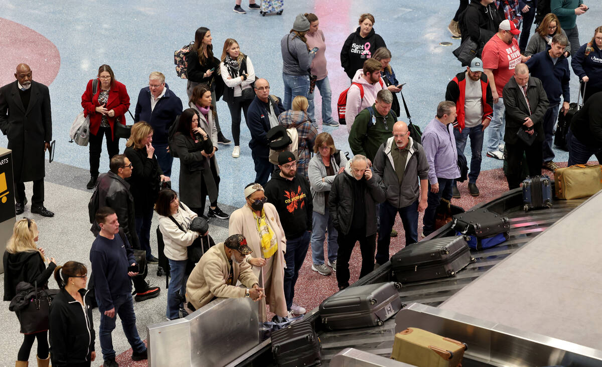 Passengers wait for their luggage in Terminal 1 at Harry Reid International Airport in Las Vega ...