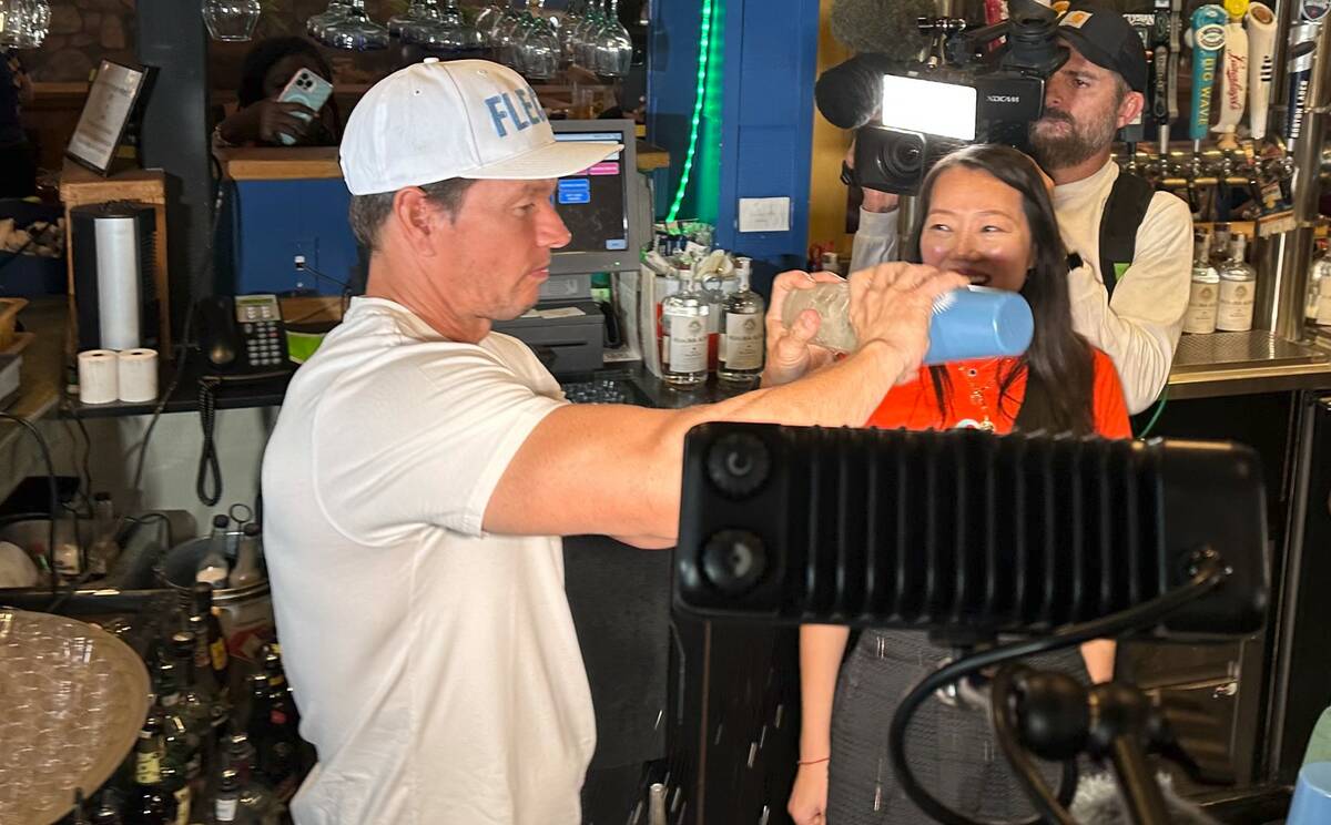 Mark Wahlberg pours Flecha Azul tequila shots during an appearance at On The Border Mexican Gri ...