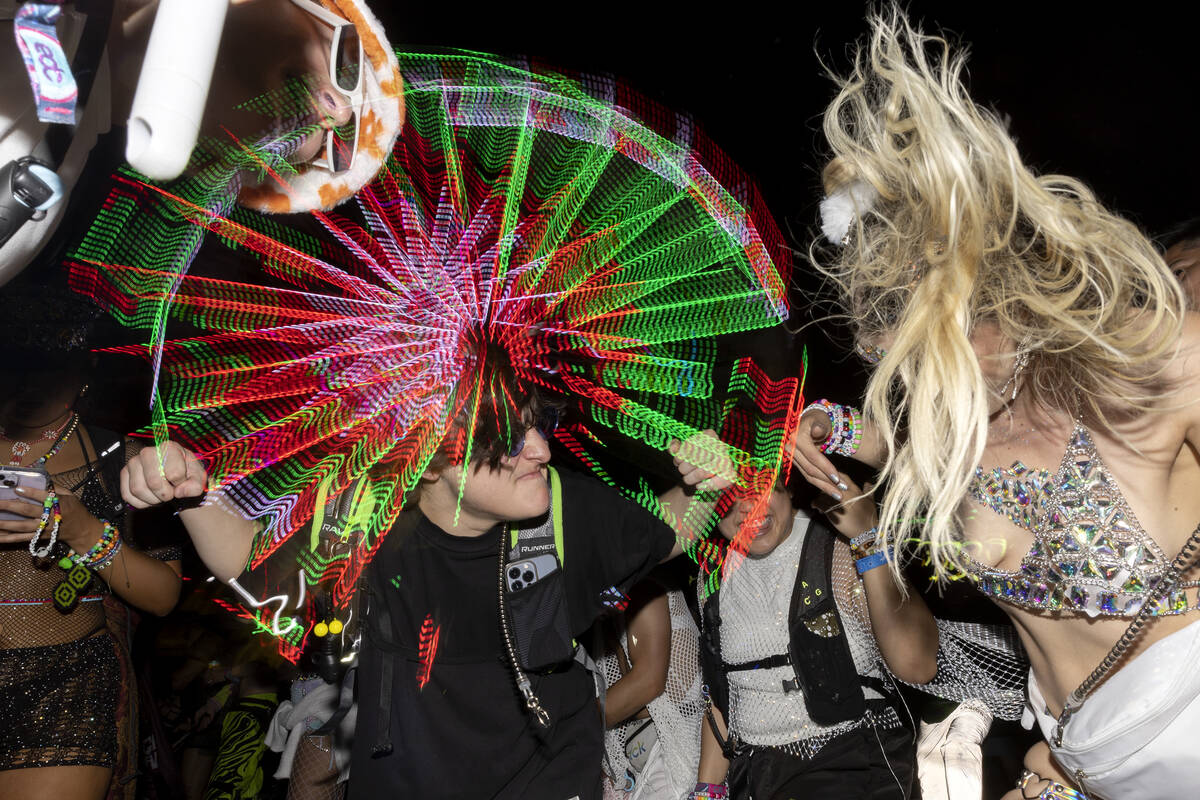 Attendees rock out to electronic dance music during the second day of Electric Daisy Carnival o ...