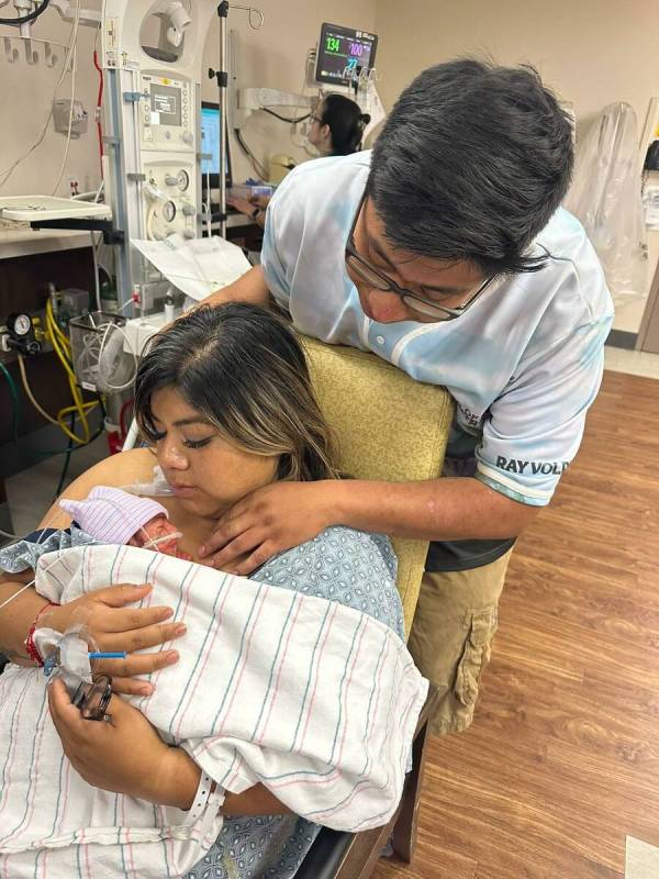 Cristina Celis, who went into labor at the Electric Daisy Carnival, holds her newborn daughter ...
