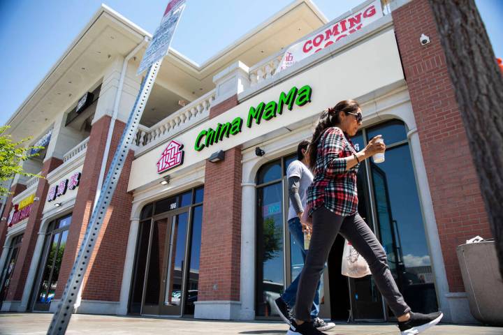 People walk in front of the new location for China Mama in Shanghai Plaza in Chinatown, where t ...