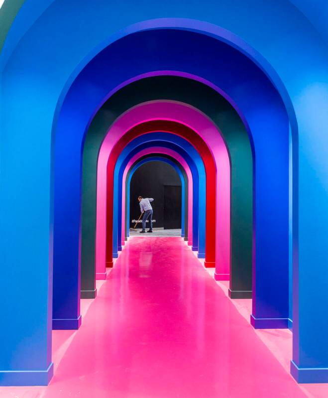 Sales and marketing manager Billy Pierro sweeps the floor at the end of a multi-colored passage ...