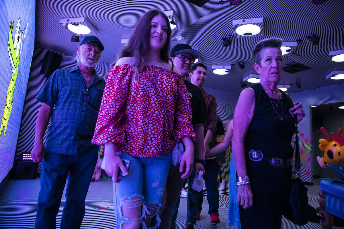 A group of people journey from one room to the next during a tour through the Fantasy Lab, an i ...