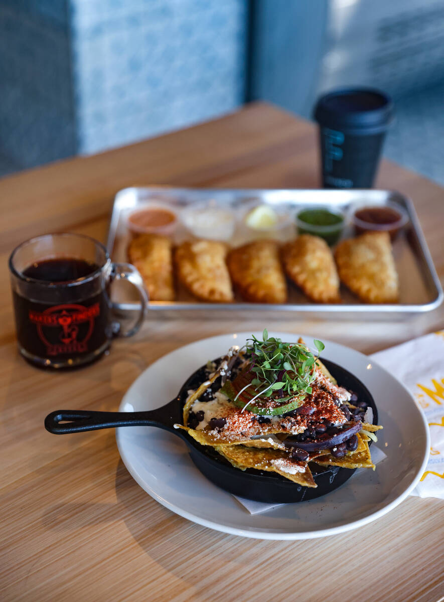 Chilaquiles, made with salsa verde, tortilla chips, folded egg, black beans, onion and jalapeñ ...