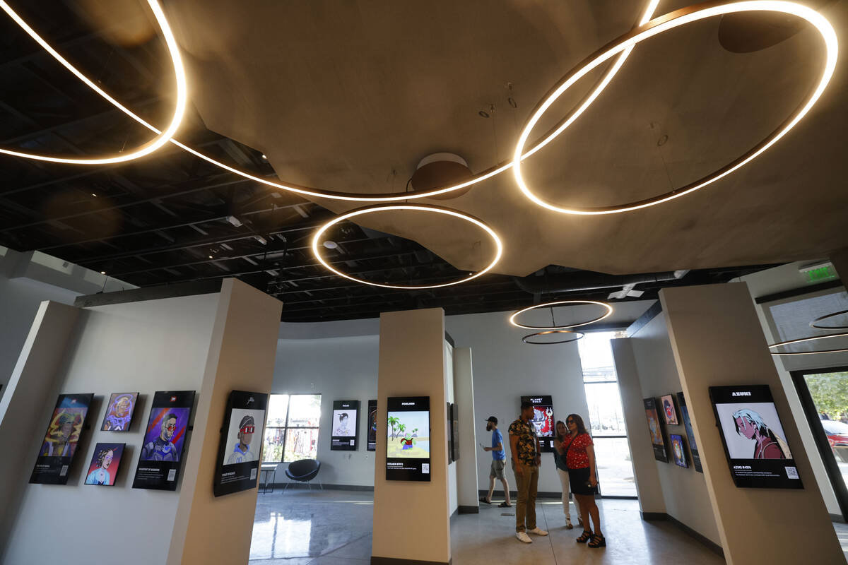 People look at NFT digital arts at JRNY Gallery, Friday, July 7, 2023, in Las Vegas. (Chitose S ...