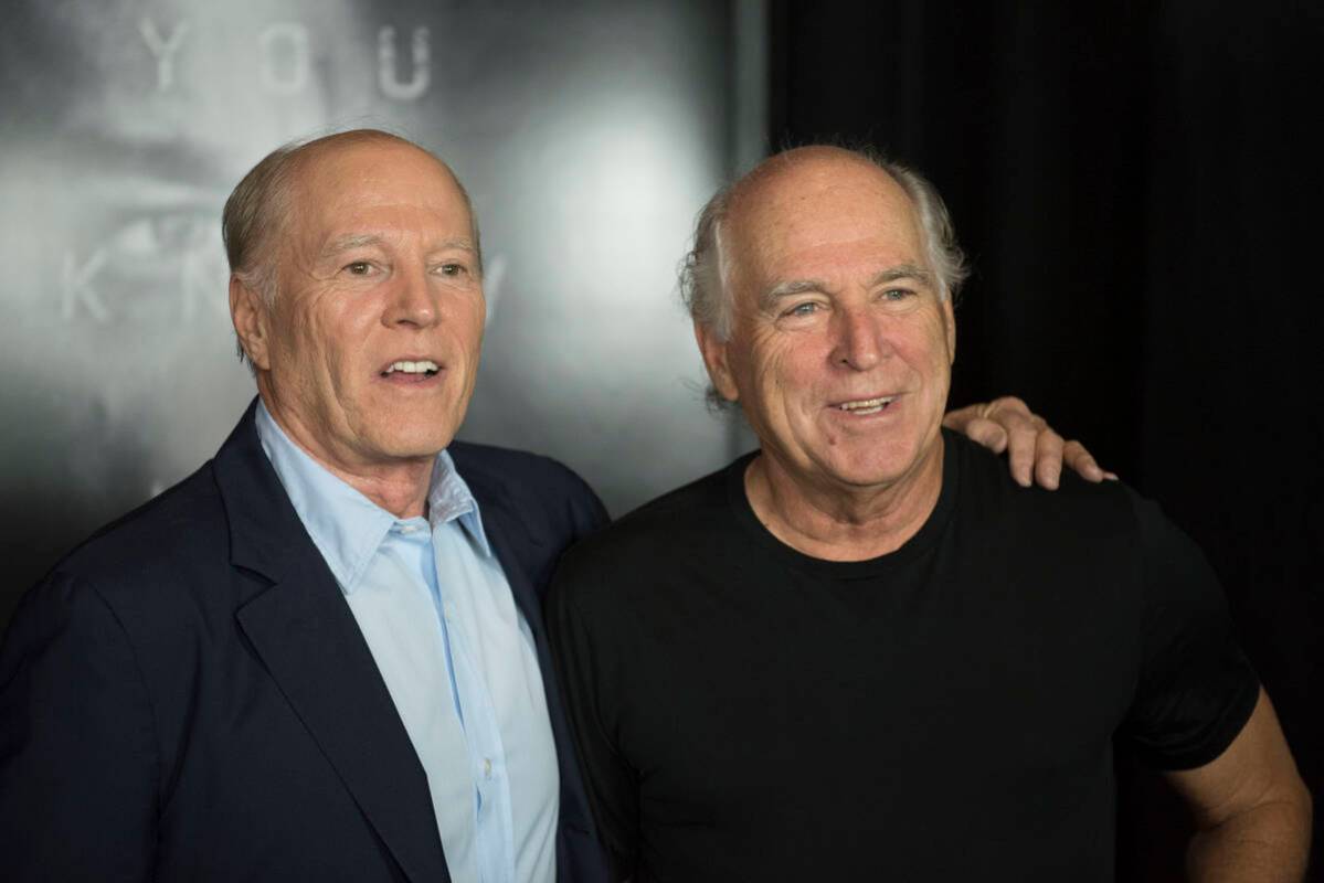 Frank Marshall and Jimmy Buffett arrive on the red carpet for the premiere of "Jason Bourne" at ...