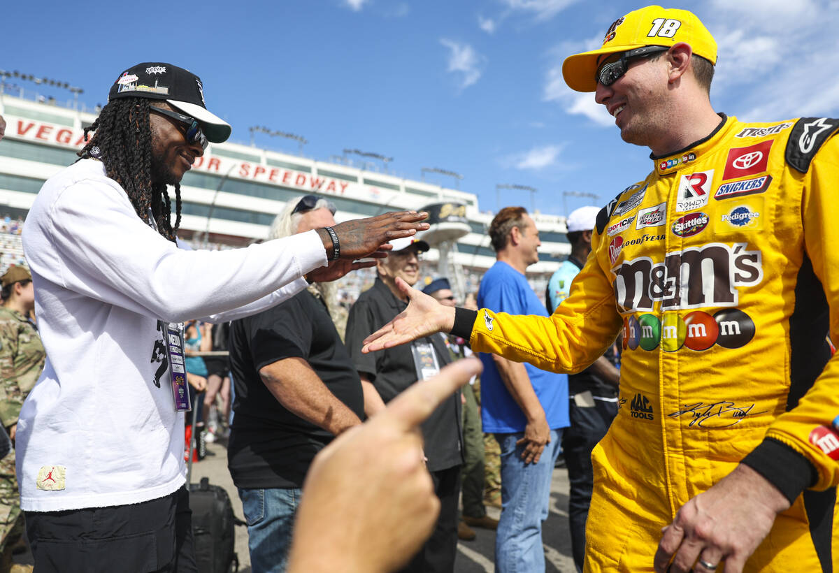Honorary pace car driver Davante Adams of the Raiders greets driver Kyle Busch before last year ...