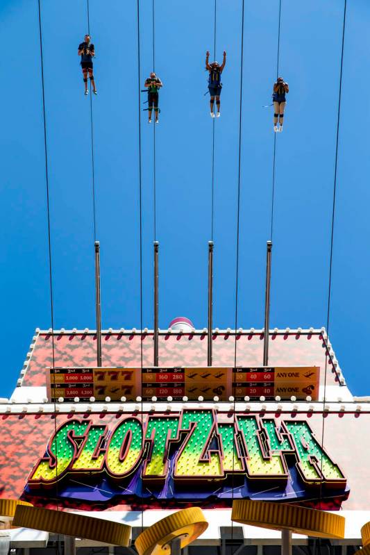 Slotzilla riders leave the platform for a run down the zipline at the Fremont Street Experience ...