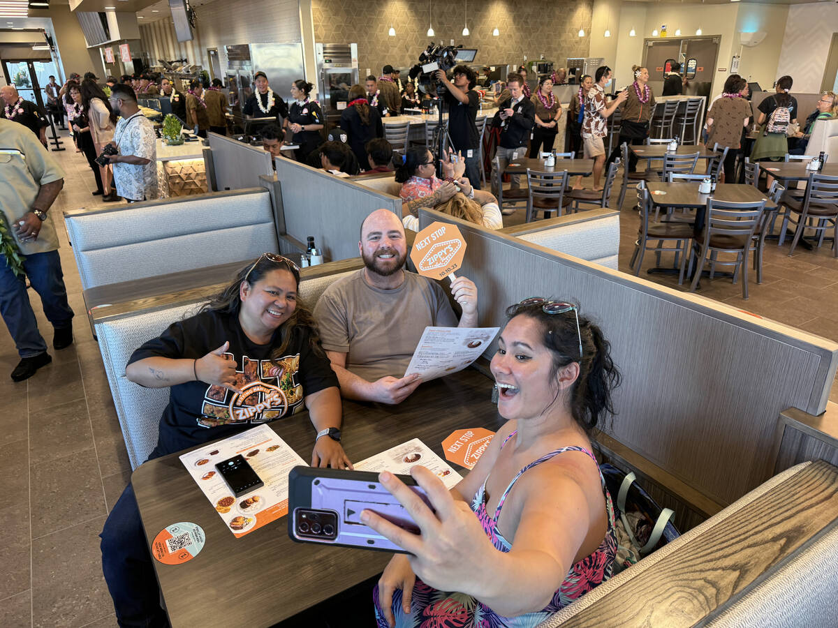 Jan Dale, from left, Michael Russell and Tifanie Silver, all of Las Vegas, take a photo as they ...