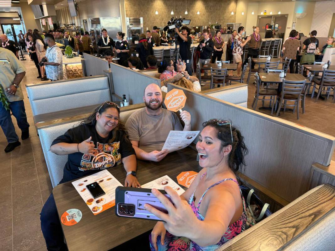 Jan Dale, from left, Michael Russell and Tifanie Silver, all of Las Vegas, take a photo as they ...