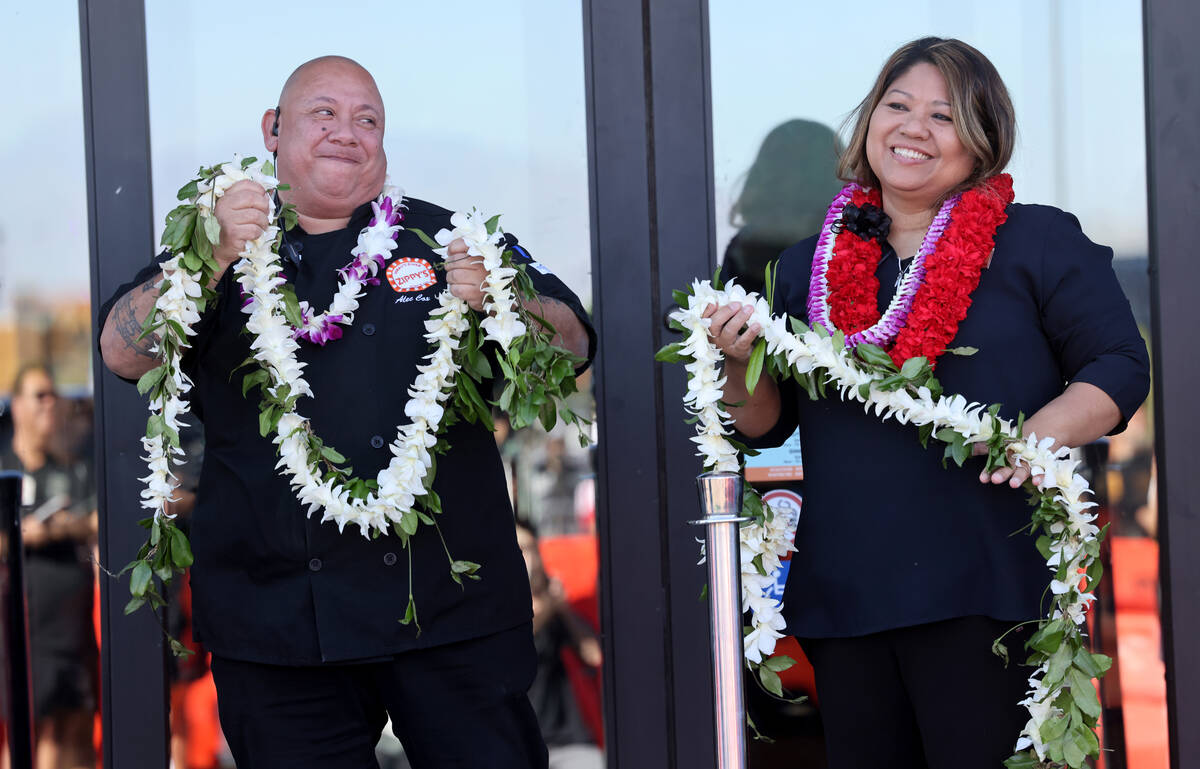 Alec Cox, operations manager, and Belma Soliven, senior operations director, participate in the ...