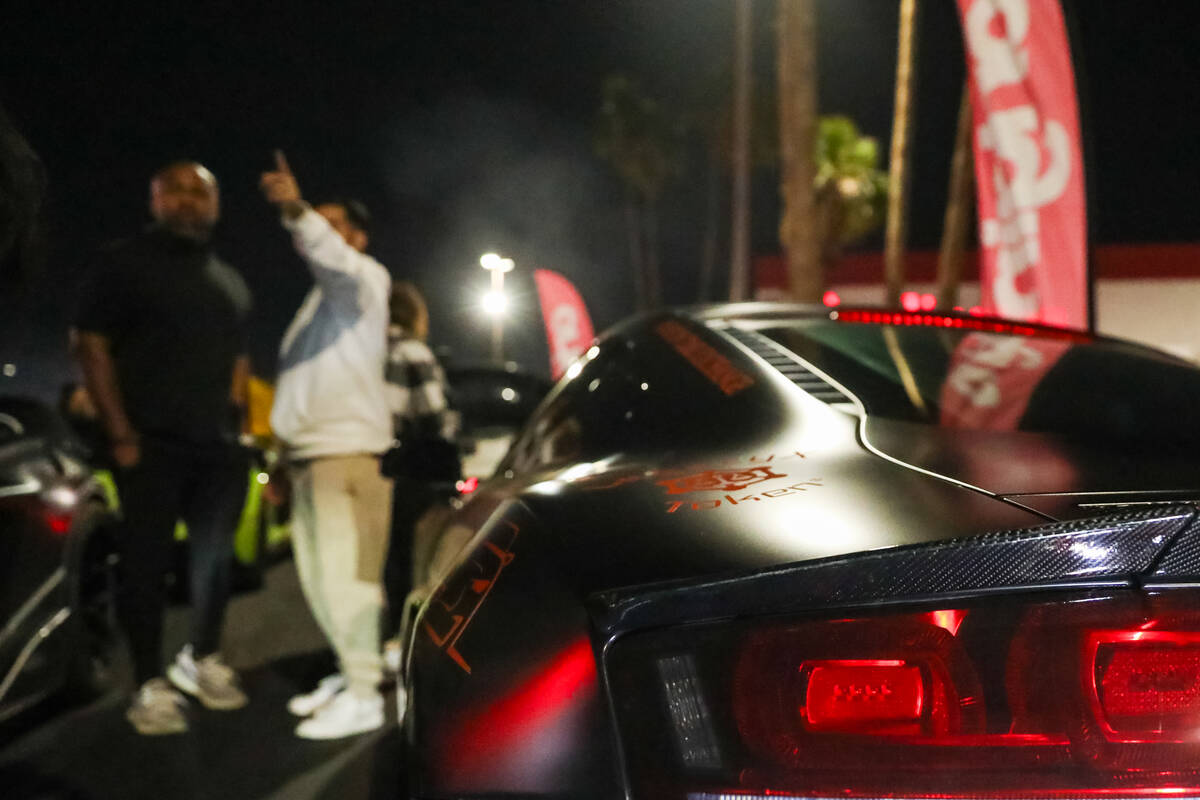 Sports car enthusiasts admire cars at The Vegas Meet car show, a separate SEMA event down the r ...