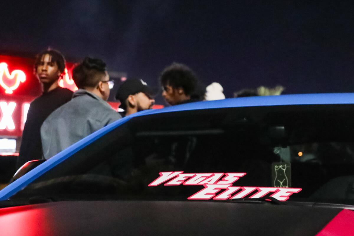 Sports car enthusiasts admire cars at The Vegas Meet car show, a separate SEMA event down the r ...