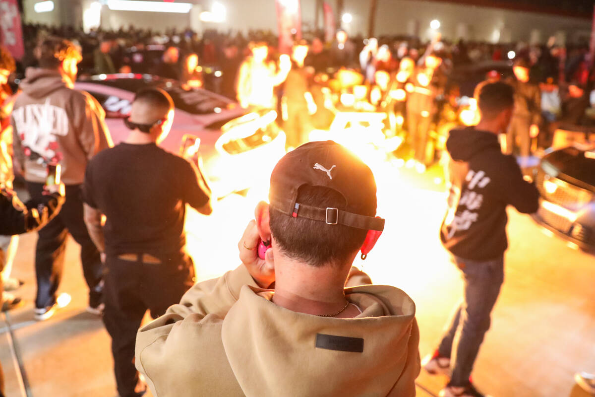 Sports car enthusiasts admire cars at The Vegas Meet car show, a separate SEMA event down the r ...