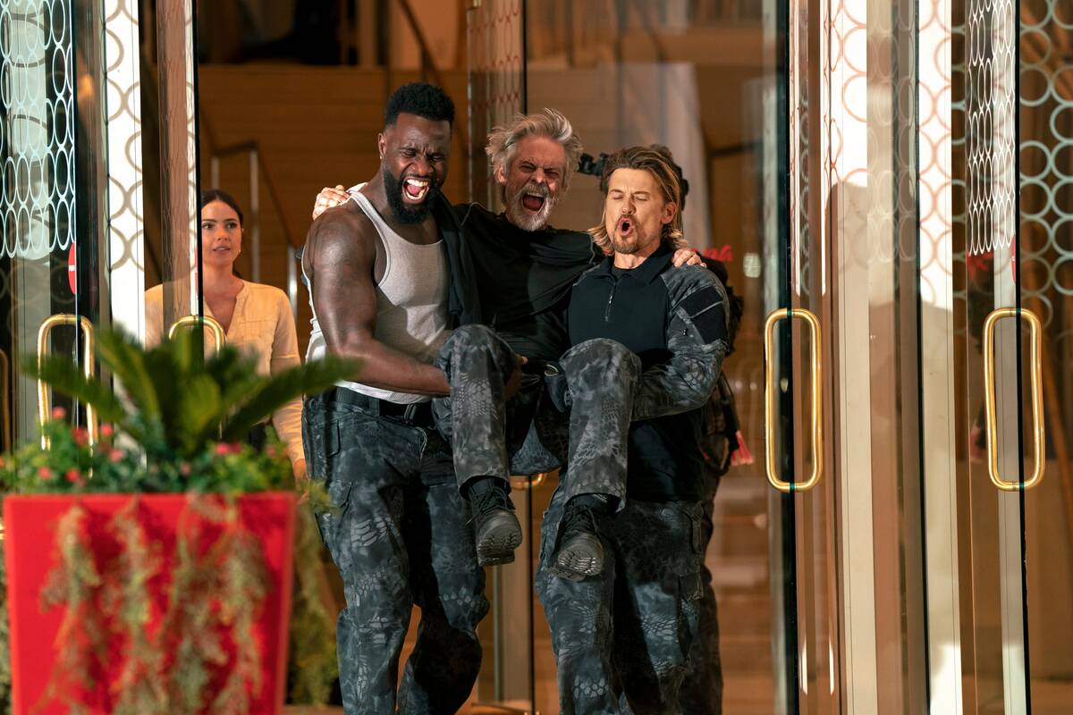 From left, Terrence Terrell, C. Thomas Howell and Nick Zano celebrate in "Obliterated." (Ursula ...