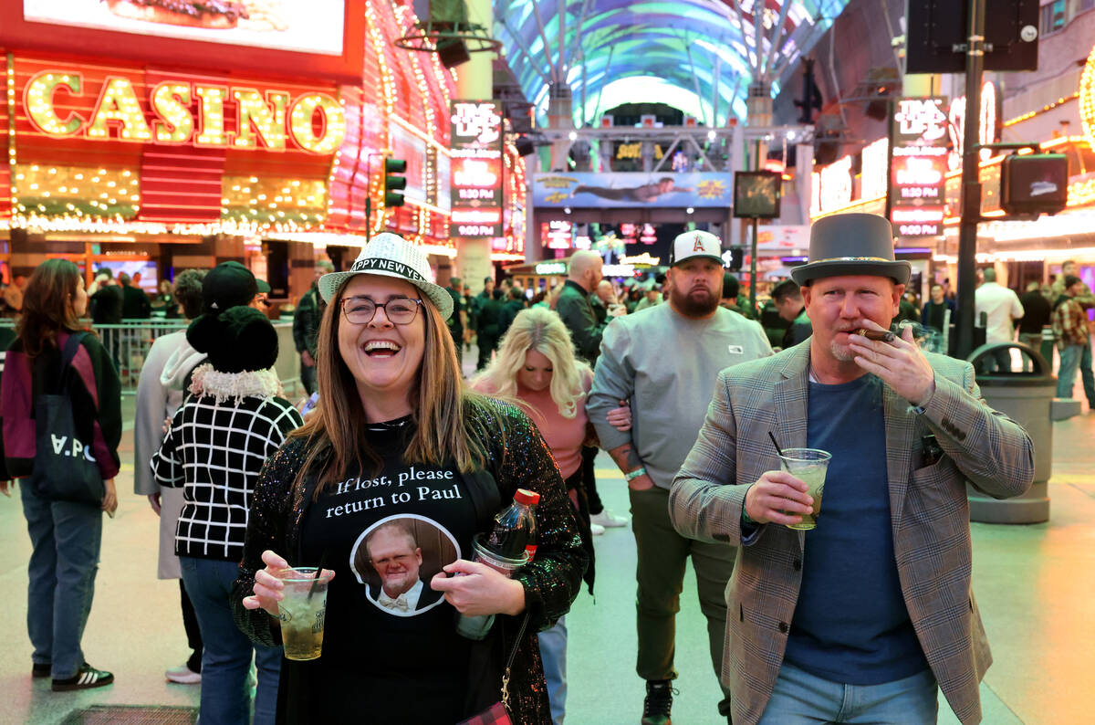 New Year’s Eve revelers Sammy Jo Jones and Paul Bennett, both of Hot Springs Ark., celeb ...