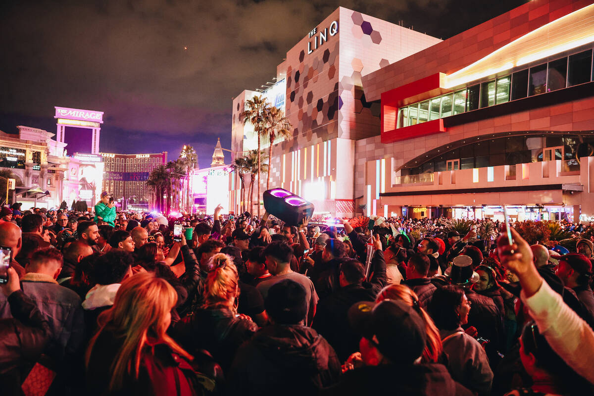 A speaker is lifted into the air as people dance on the Strip on Sunday, Dec. 31, 2023, in Las ...