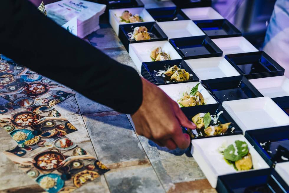Dishes from Esther’s Kitchen are laid out for attendees at the Taste of NFL event at the ...