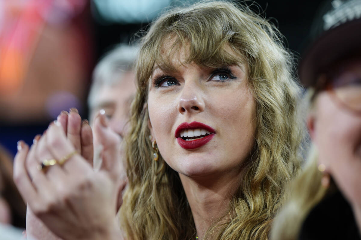 FILE - Taylor Swift stands on the field after an AFC Championship NFL football game between the ...