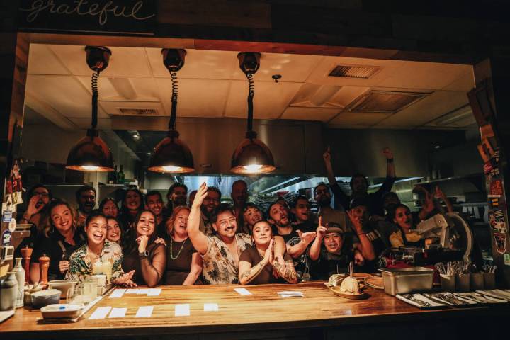 The staff at Esther’s Kitchen pose for photographs on the last night of service before moving ...