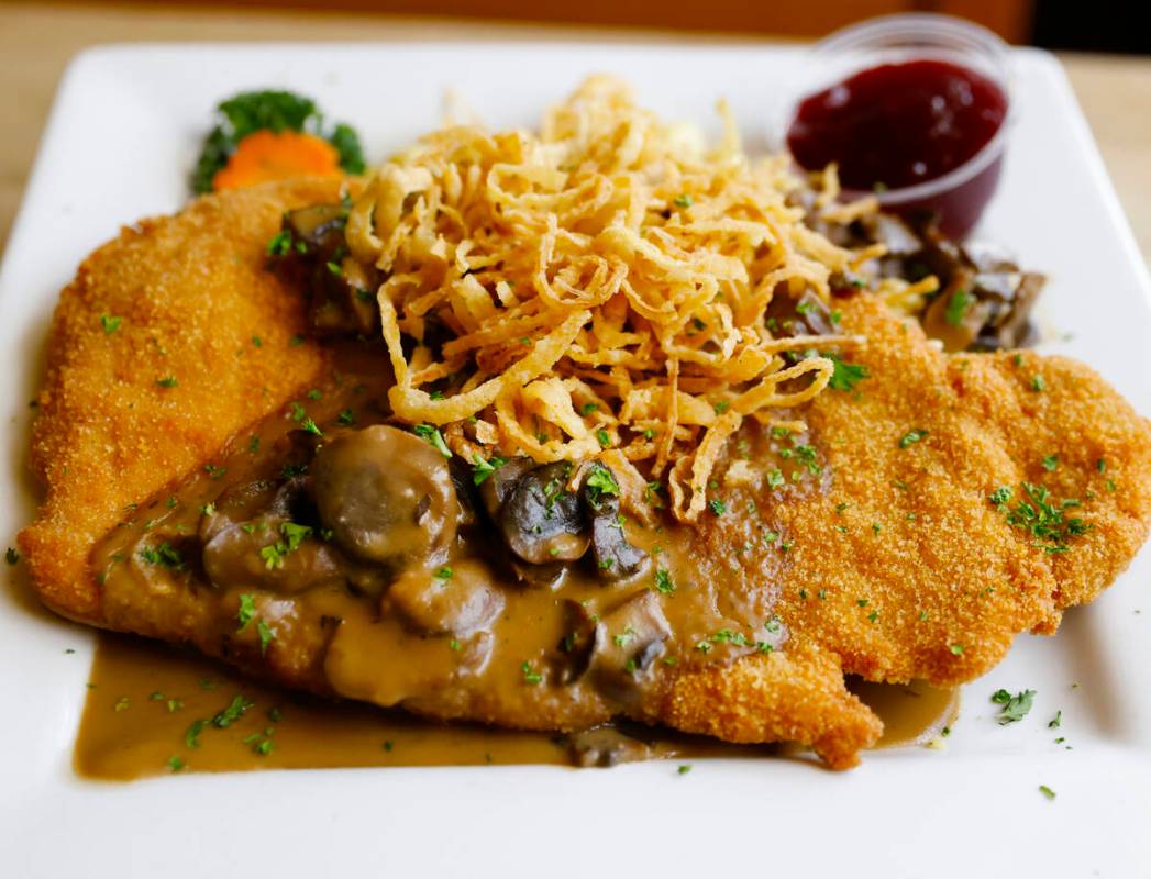 Paniertes Jägerschnitzel, breaded pork cutlet pan-fried and served with homemade spätzle and ...