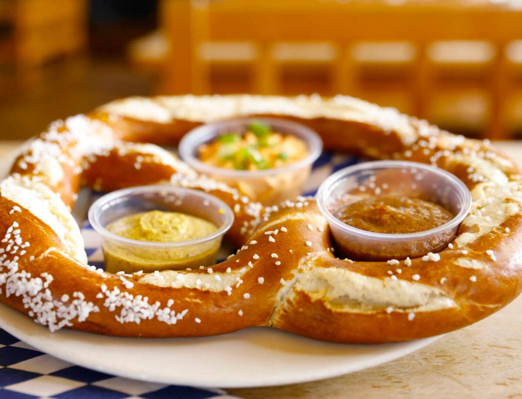 Riesenbrezen Combo, a giant pretzel served with Obatzda cheese, sweet mustard and onion mustard ...